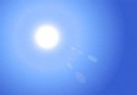 Sunburst On Blue Sky Background Stock Photo