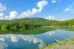 Landscape Of The Dam And Lake On The Mountain With Tree And Forest And The Boat Stock Photo