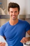 Smiling Man In The Kitchen Stock Photo