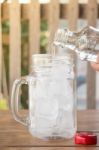 Drinking Water Is Poured Into Iced Glass Stock Photo