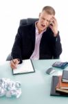 Upset Businessman at his desk Stock Photo