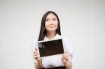 Portrait Of Thai High School Student Uniform Beautiful Girl Using Her Tablet Stock Photo