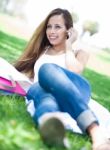 Young Women Lying In Park Stock Photo