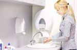 Woman Washing Hands In Restroom Stock Photo