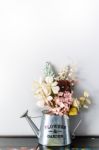 Watering Can Filled With Flower And Bear Doll Stock Photo