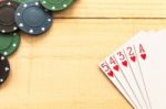 Cards And Poker Chips On Wooden Background Stock Photo