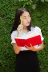 Thai Adult Student University Beautiful Girl Reading Red Book Stock Photo