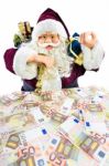 Model Of Santa Claus With Gifts And Euro Money Stock Photo