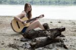 Girl Near Extinguished Campfire On A Sandy Beach Stock Photo