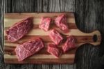 Raw Angus Beef Slices On The Wooden Board Top View Stock Photo