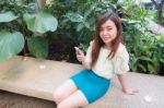 Portrait Of Thai Student University Beautiful Girl Using Her Smart Phone Stock Photo