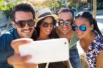 Portrait Of Group Friends Taking Photos With A Smartphone Stock Photo