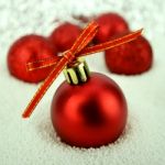 Red Christmas Ball With Bokeh In Merry Metal Tone Stock Photo