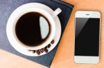 Coffee And Smartphone Mobile On Wood Table Stock Photo