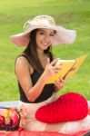 Beautiful Young Woman Reading Book At Park Stock Photo