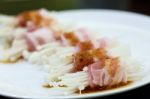 Raw Bacon Wrapped With Needle Mushroom Stock Photo