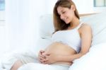 Pregnant Woman Relaxing At Home Stock Photo