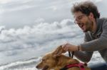 Man Playing With The Dog Stock Photo