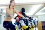 Young People With Fitness Bicycle In The Gym Stock Photo