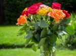 A Vase Of Colourful Roses Out In The Garden Stock Photo