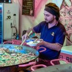 Man Selling Paella On A Market Stall In Bergamo Stock Photo