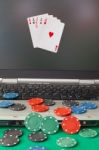 Poker Chips And Cards And A Laptop On Casino Baize Stock Photo