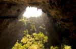 Sunlight Through A Cave Hole In Thailand Stock Photo