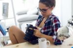 Young Woman Photographer Checking Previews On Camera In The Stud Stock Photo