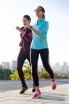 Beautiful Couple Running In The Street Stock Photo