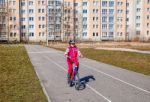 Little Girl In A Safety Helmet Riding A Bicycle Stock Photo