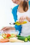 Pretty Young Woman Cooking At Home Stock Photo