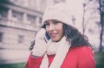 Woman In Red Coat And Wool Cap And Gloves With Smartphone In Han Stock Photo