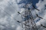 Power Lines With Clouds In The Background Stock Photo