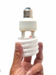 Man Holding A Light Bulb On A White Background Stock Photo