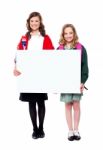 Schoolgirls Holding Blank Banner Stock Photo