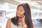 Portrait Of Thai Student Teen Beautiful Girl Using Her Phone And Smile Stock Photo