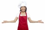 Female Chef Showing Welcome Gesture Stock Photo