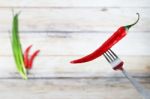 Red Hot Chili Pepper With Water Drops On Fork Stock Photo