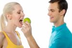 Guy Feeding Green Apple To Lover Stock Photo