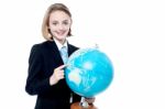 Business Girl Indicating A Place In Globe Map Stock Photo