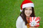 Santa Claus Hat With Red Christmas Gift Box Stock Photo