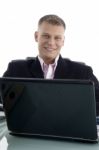 Businessman At Desk With Laptop Stock Photo