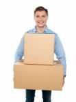 Young Man Holding Cardboard Box Stock Photo