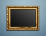 Empty Golden Vintage Frame On Wallpaper Background Stock Photo