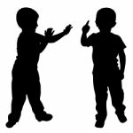 Silhouettes Of Two Little Boys Stock Photo