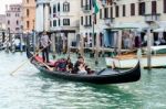 Gondolier Ferrying People In Venice Stock Photo