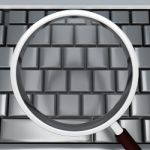 Magnifying Glass And Keyboard Shows Blank Copyspace Searching Stock Photo