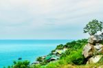 The View Of Sand Beach And Sea Wave With Rock And Cloudy On Afternoon Stock Photo