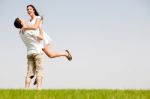 Young Couple Fooling Around On The Park Stock Photo