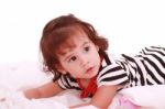 Little Girl Lying On Bed Stock Photo